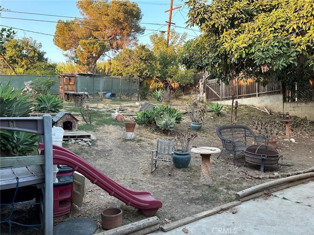 view of yard with a fire pit