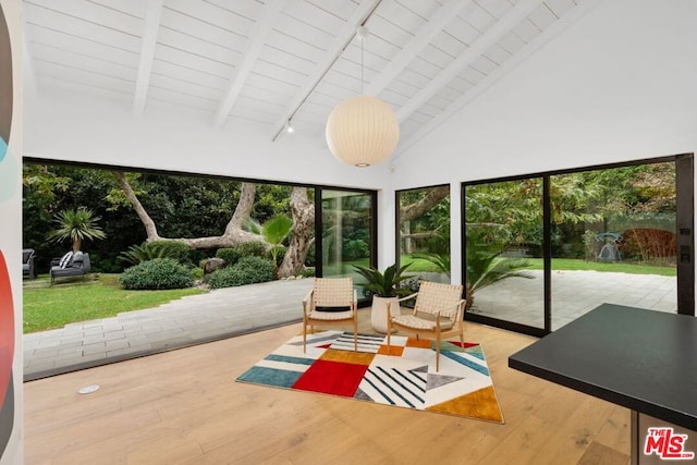 sunroom featuring vaulted ceiling with beams and wood ceiling