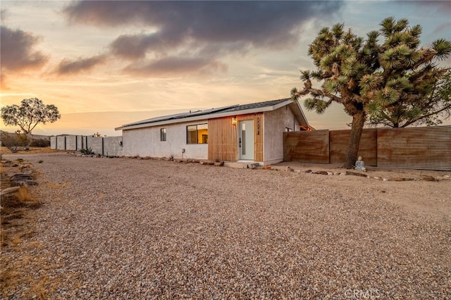 view of back house at dusk