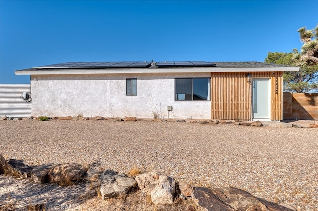 rear view of house with solar panels