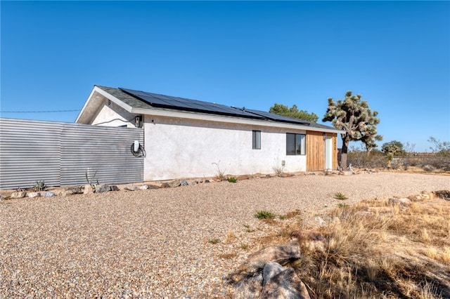 view of home's exterior featuring solar panels