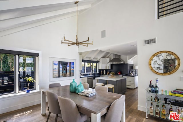 dining room featuring dark hardwood / wood-style floors and high vaulted ceiling