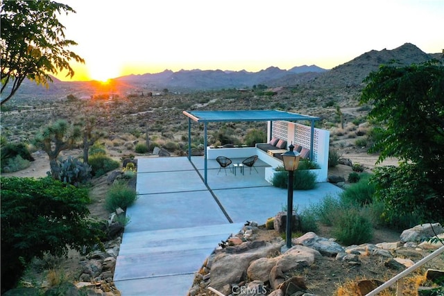 patio terrace at dusk with a mountain view