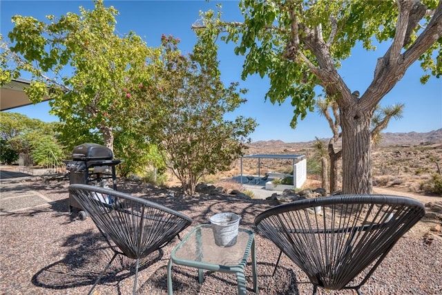 view of patio featuring a grill and a mountain view