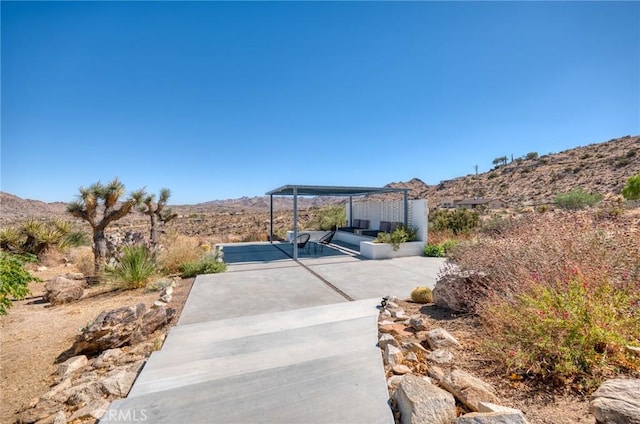 view of patio / terrace featuring a mountain view and a pergola