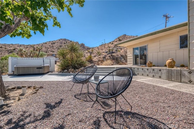 view of yard featuring a mountain view and a hot tub