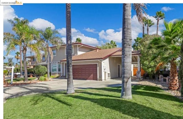 view of front of home featuring a front yard and a garage