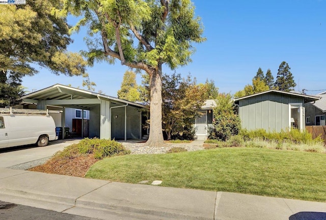 ranch-style house featuring a front lawn and a carport