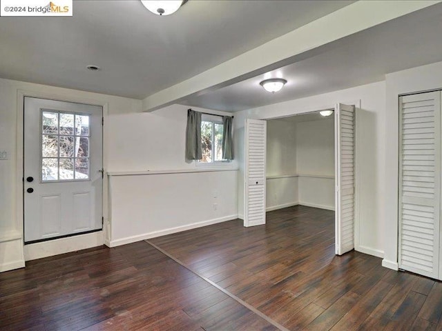 entryway with dark hardwood / wood-style floors and plenty of natural light