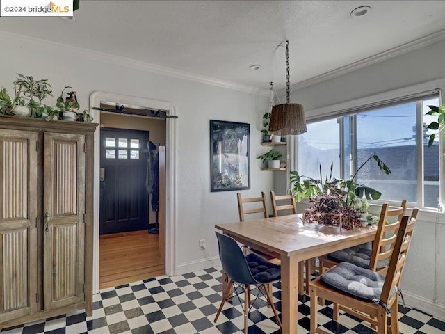 dining area featuring light hardwood / wood-style floors and ornamental molding