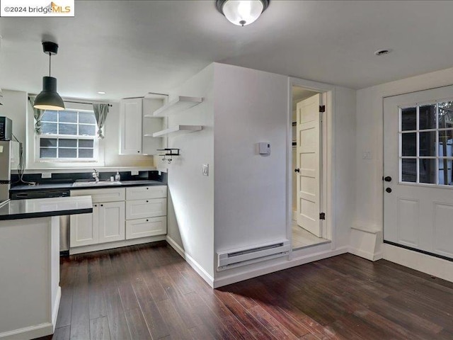 kitchen with dark hardwood / wood-style floors, hanging light fixtures, sink, a baseboard radiator, and white cabinets