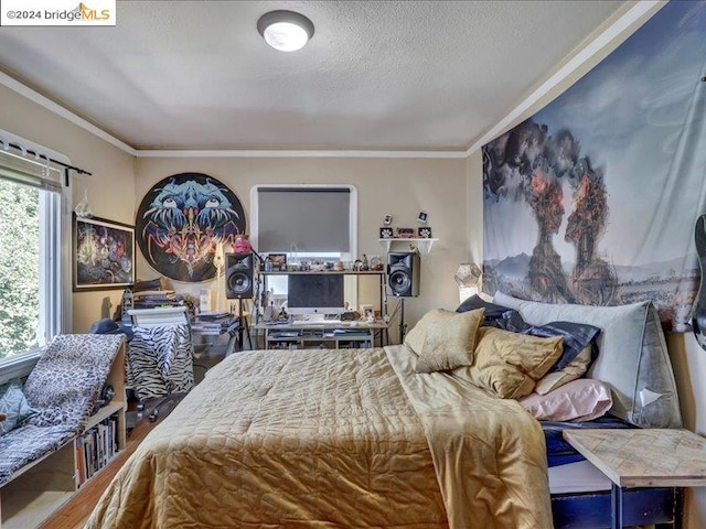 bedroom featuring crown molding, hardwood / wood-style flooring, and a textured ceiling