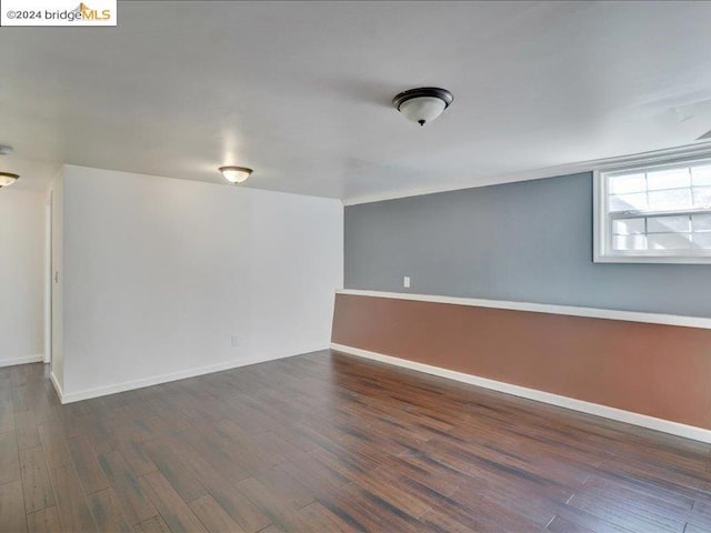 spare room with dark hardwood / wood-style floors