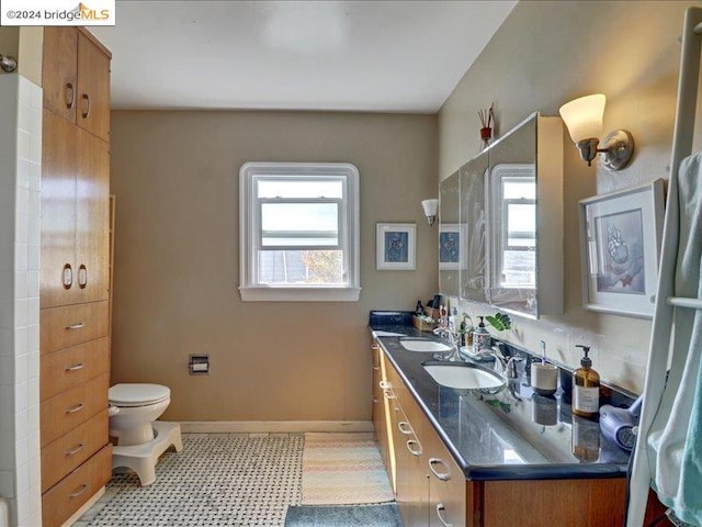 bathroom with vanity, toilet, and tile patterned flooring