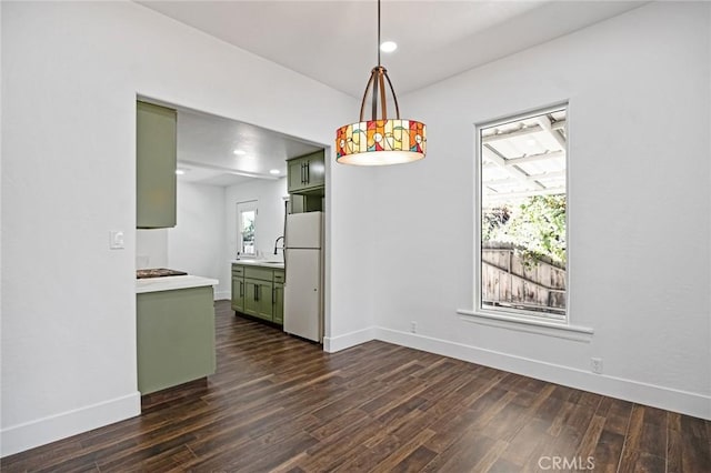 325 W Bush St, Lemoore, CA 93245 - unfurnished dining area with dark wood-type flooring, baseboards, a sink, and recessed lighting