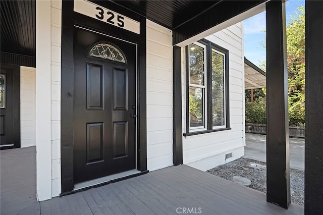 doorway to property featuring covered porch