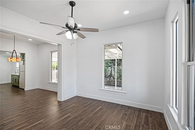 spare room featuring ceiling fan and dark hardwood / wood-style flooring