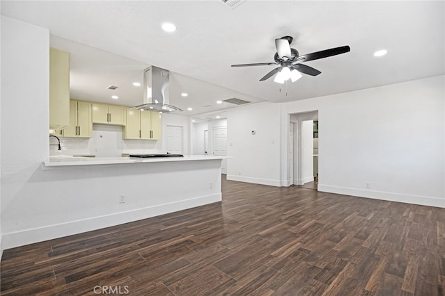 unfurnished living room with ceiling fan and dark hardwood / wood-style floors