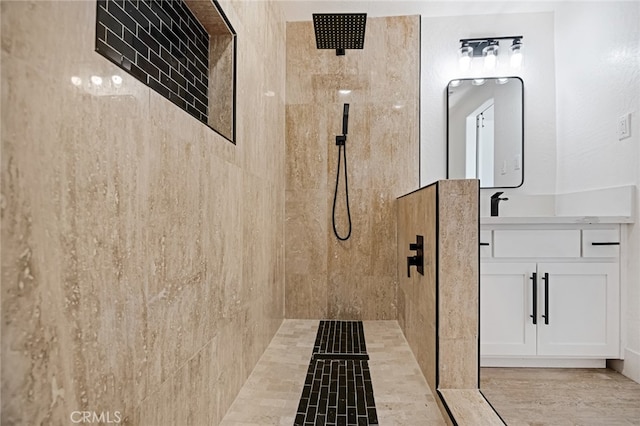 bathroom featuring vanity and a tile shower