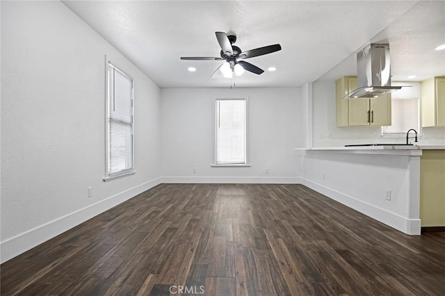 325 W Bush St, Lemoore, CA 93245 - unfurnished living room with dark wood-style flooring, baseboards, ceiling fan, a sink, and recessed lighting