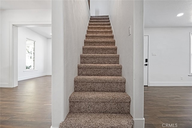 staircase featuring wood-type flooring