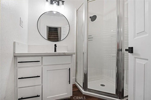 325 W Bush St, Lemoore, CA 93245 - bathroom with a stall shower, a textured wall, vanity, and wood finished floors