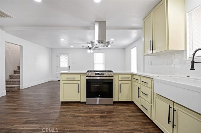 kitchen featuring stainless steel range, island exhaust hood, dark wood-type flooring, and cream cabinetry