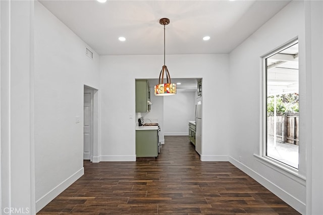 unfurnished dining area with dark hardwood / wood-style floors