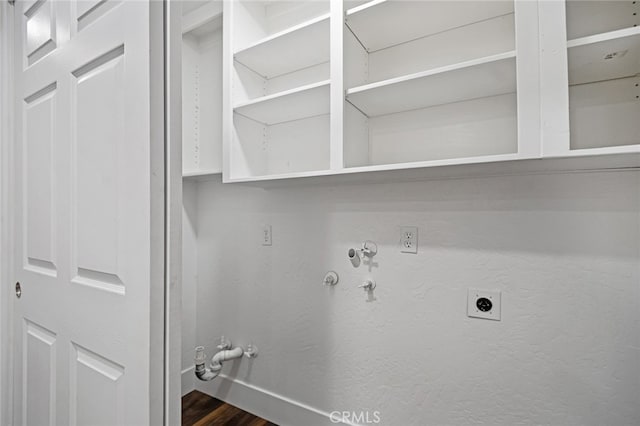 clothes washing area featuring electric dryer hookup, hookup for a gas dryer, and dark hardwood / wood-style floors