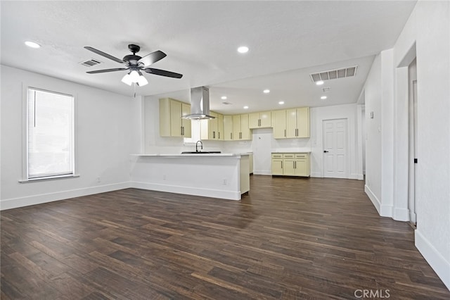 unfurnished living room featuring sink, dark wood-type flooring, a textured ceiling, and ceiling fan