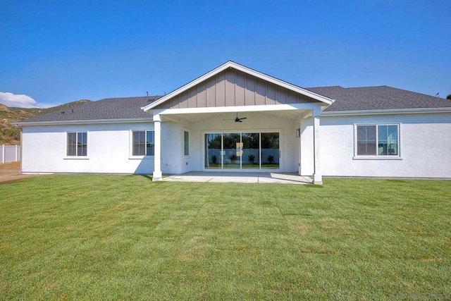 back of house featuring a yard, a patio, and ceiling fan