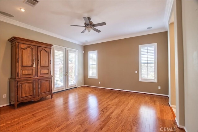 unfurnished room featuring french doors, light wood-type flooring, ceiling fan, and crown molding