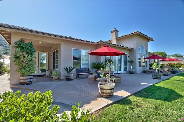 back of property featuring french doors and a patio area