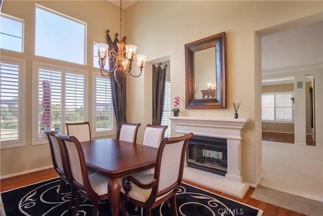 dining area featuring hardwood / wood-style floors and a notable chandelier