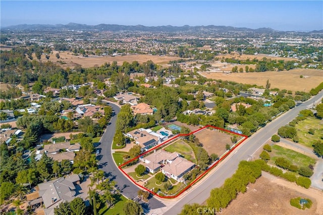 birds eye view of property with a mountain view