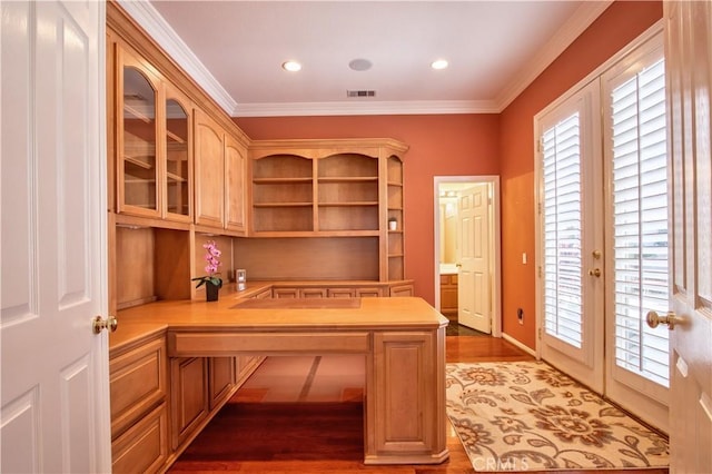 unfurnished office featuring french doors, dark wood-type flooring, and ornamental molding