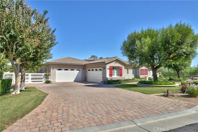 view of front facade featuring a garage and a front lawn