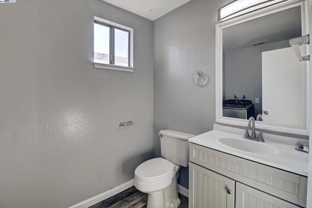 bathroom featuring vanity, toilet, and wood-type flooring