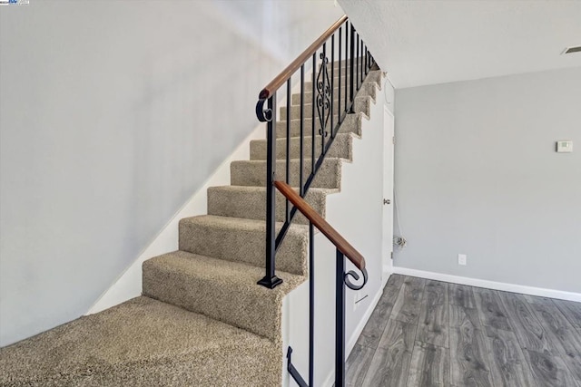 staircase featuring wood-type flooring