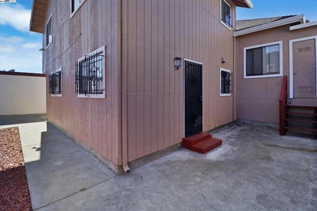 view of side of property with a patio area