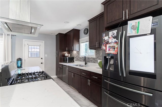 kitchen with stainless steel appliances, light stone countertops, sink, and a wealth of natural light