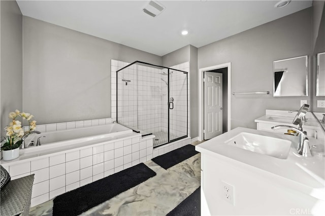 bathroom with vanity and separate shower and tub