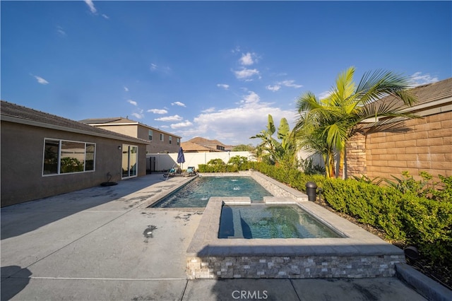 view of swimming pool featuring an in ground hot tub and a patio area