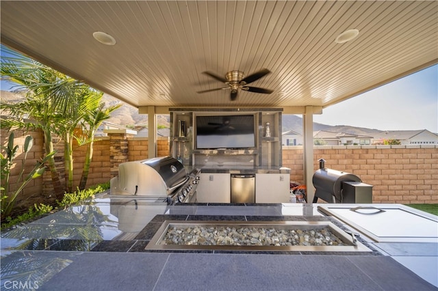 view of patio / terrace featuring area for grilling and ceiling fan