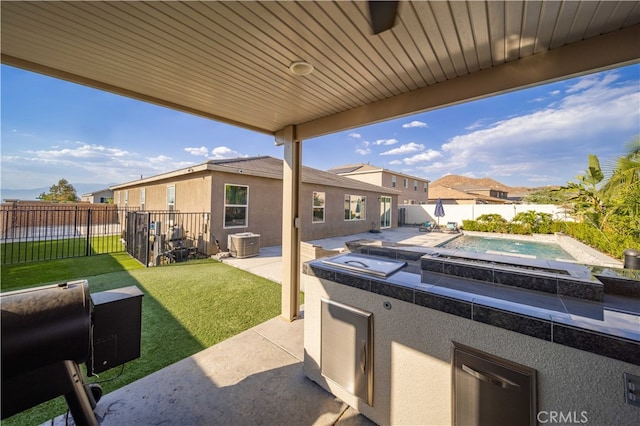 view of patio / terrace featuring central AC and a fenced in pool