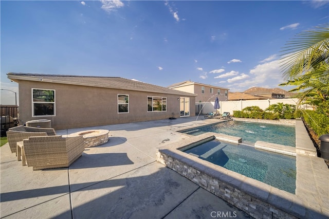 view of pool with an in ground hot tub, pool water feature, a patio, and an outdoor fire pit