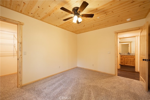 unfurnished bedroom with sink, wood ceiling, carpet floors, and ceiling fan