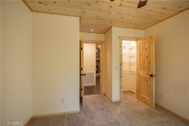 unfurnished bedroom with carpet floors, wooden ceiling, and ceiling fan