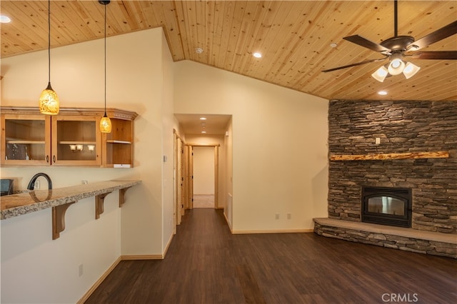 unfurnished living room featuring a fireplace, wood ceiling, dark hardwood / wood-style flooring, ceiling fan, and high vaulted ceiling