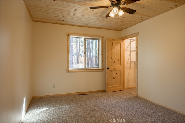 carpeted empty room with wood ceiling and ceiling fan